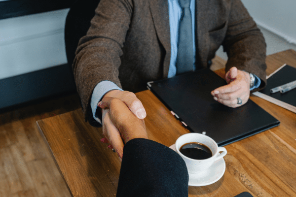 Salesperson shaking hands after a positive interaction with a new customer